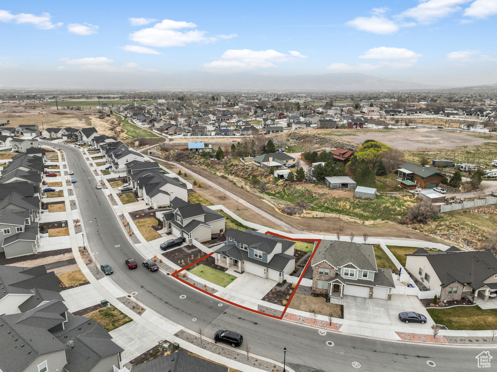 Aerial perspective of suburban area featuring property boundaries highlighted