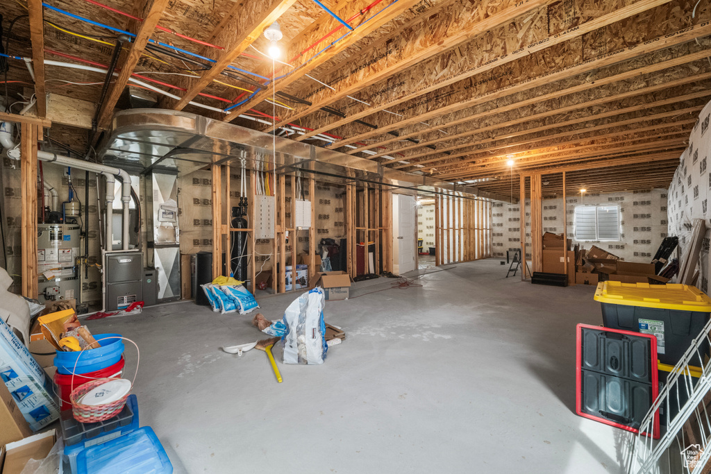 Unfinished basement with strapped water heater and heating unit