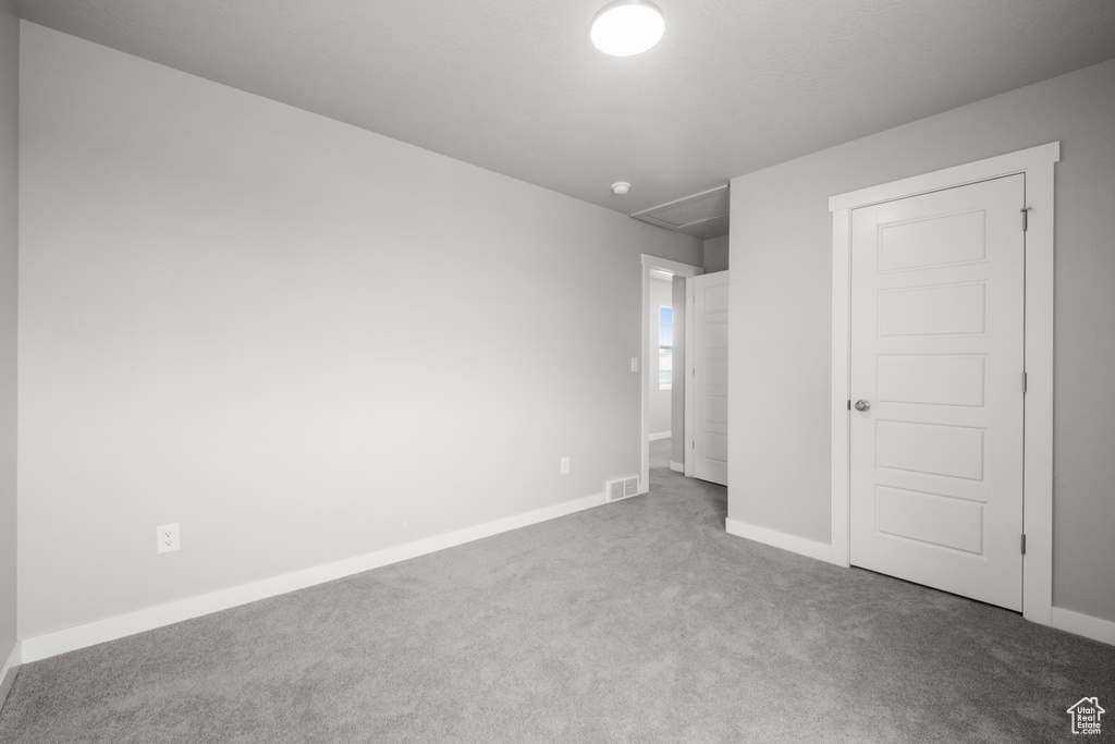 Unfurnished bedroom featuring carpet and baseboards