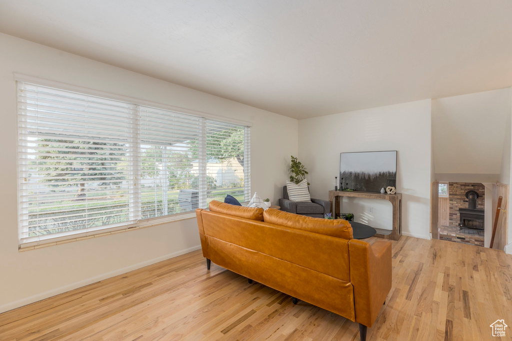 Living area featuring light wood finished floors and a wood stove