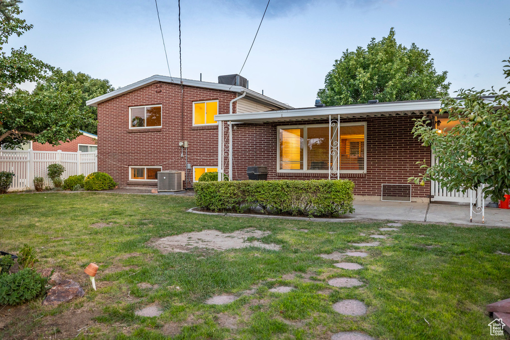 Rear view of property featuring brick siding and a patio