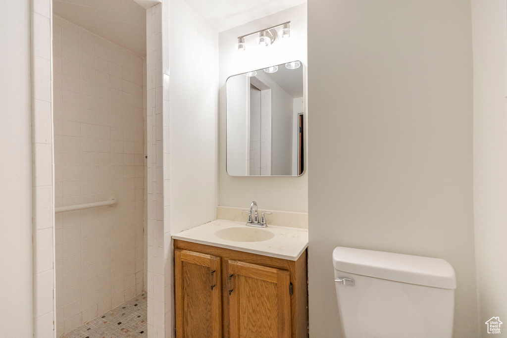 Bathroom featuring vanity and tiled shower