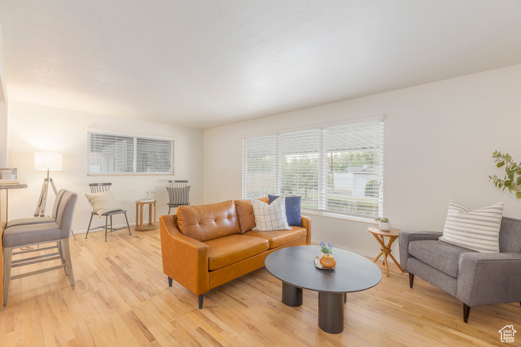 Living room featuring light wood-style flooring and baseboards