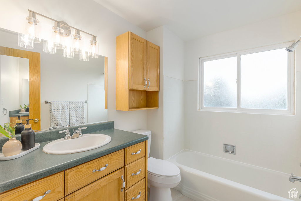 Bathroom featuring a tub to relax in, vanity, and a shower