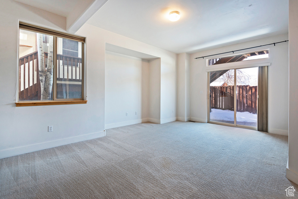 Carpeted spare room with baseboards