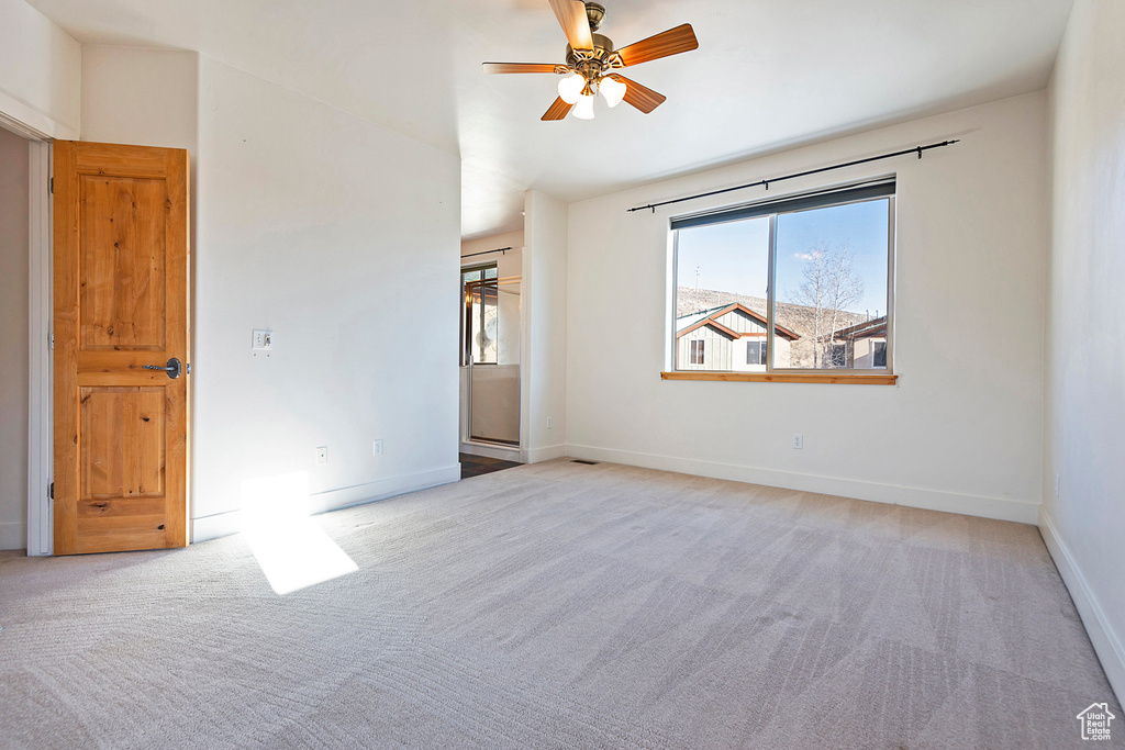 Spare room with carpet floors and a ceiling fan