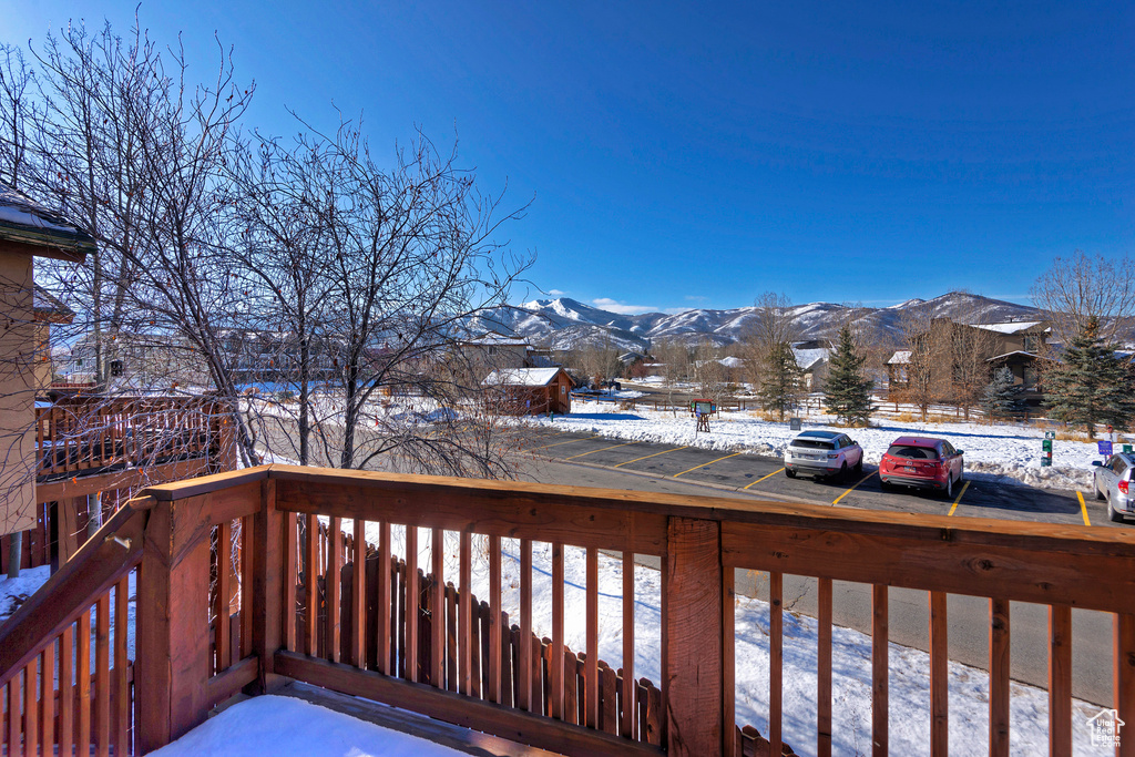 Snow covered deck featuring a mountain view