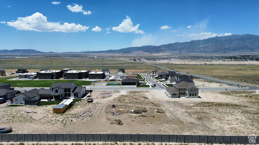 View of rural area featuring a mountain backdrop and nearby suburban area