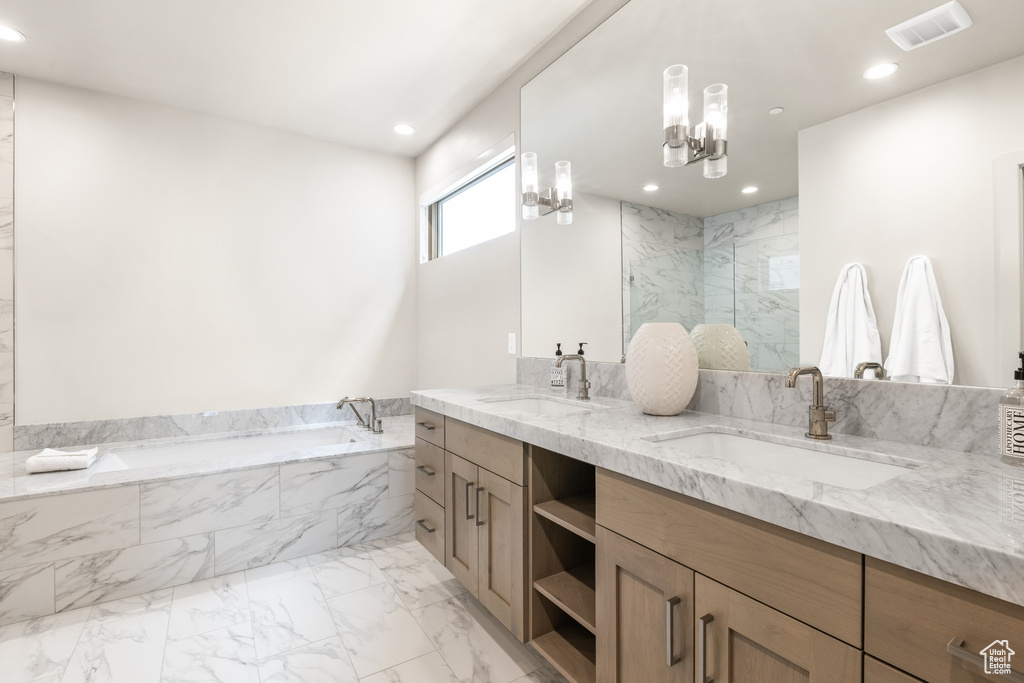 Bathroom featuring a garden tub, double vanity, marble finish flooring, recessed lighting, and a marble finish shower