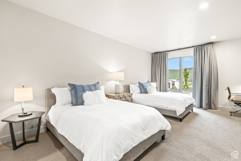 Carpeted bedroom with baseboards and recessed lighting