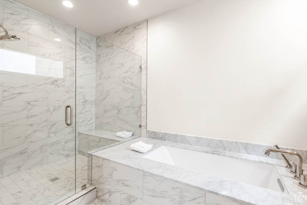 Full bath with recessed lighting, a garden tub, and a marble finish shower
