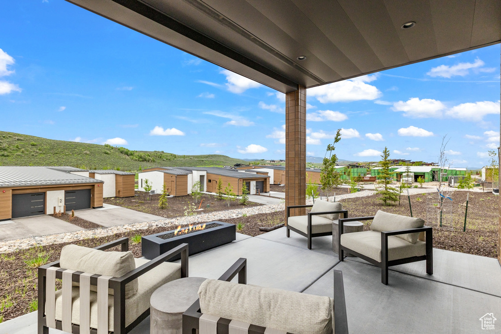 View of patio / terrace featuring an outdoor structure and an outdoor living space with a fire pit