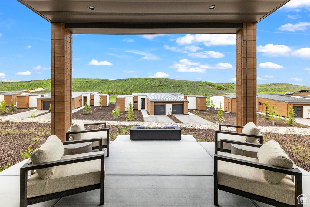 View of patio with an outdoor fire pit