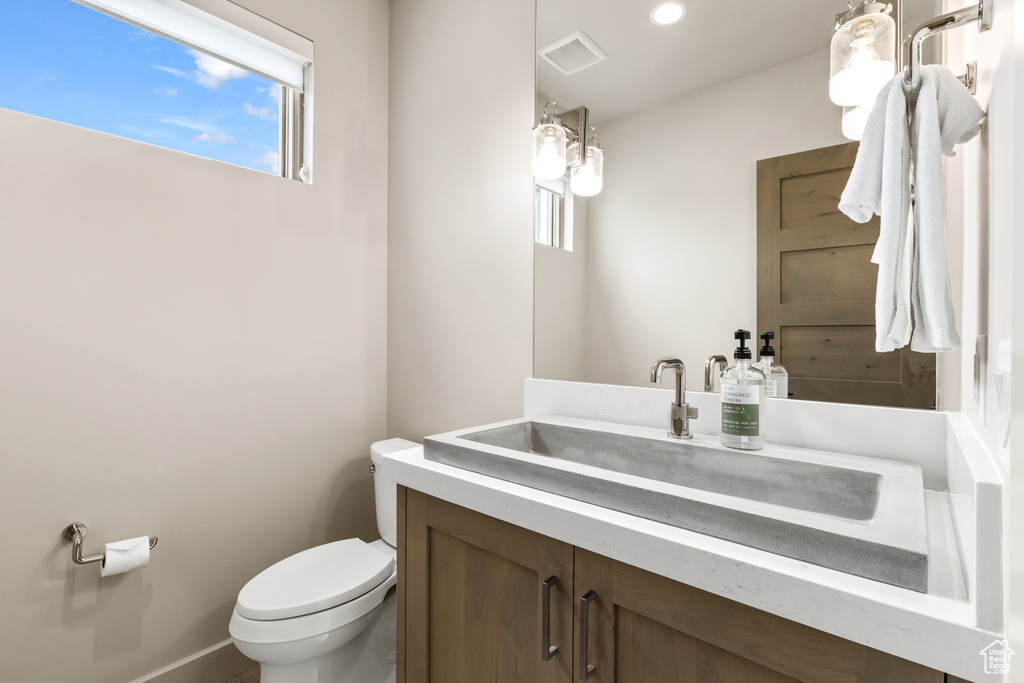 Bathroom with vanity and recessed lighting