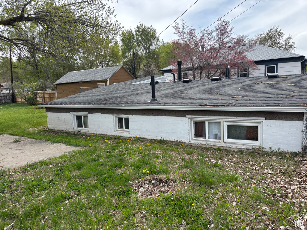 View of side of home featuring a shingled roof