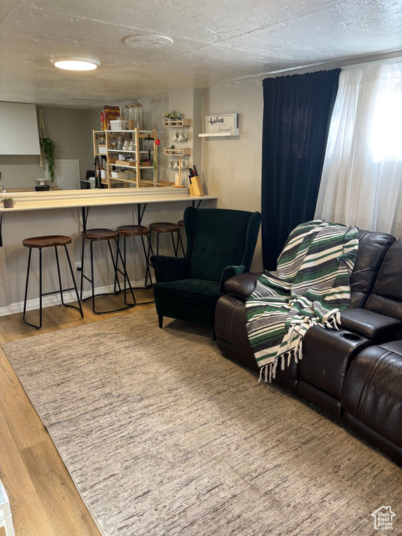 Living room with a textured ceiling and wood finished floors