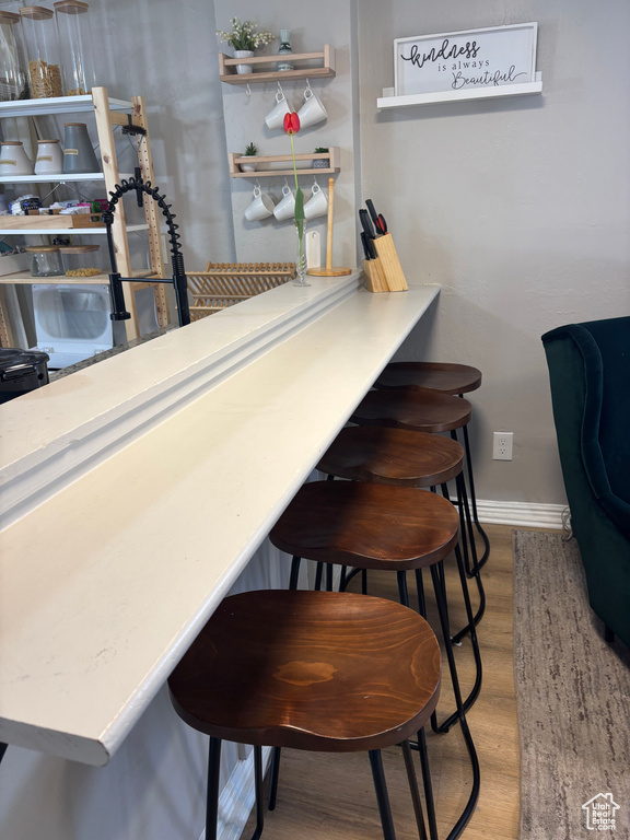 Bar featuring baseboards and wood finished floors