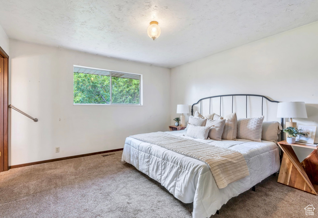 Carpeted bedroom featuring baseboards