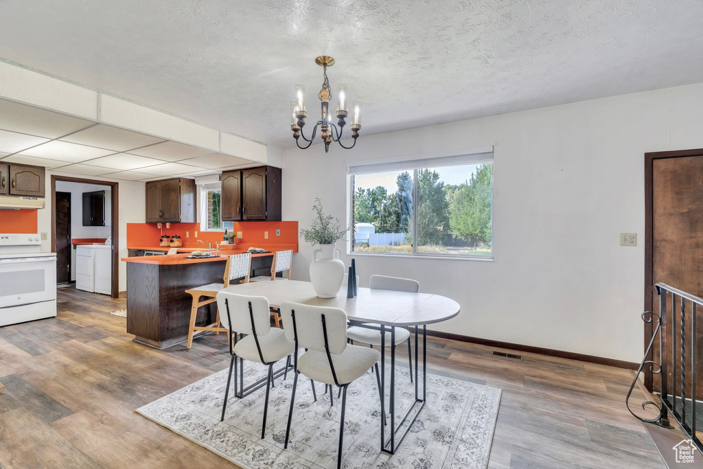 Dining space featuring a chandelier and wood finished floors