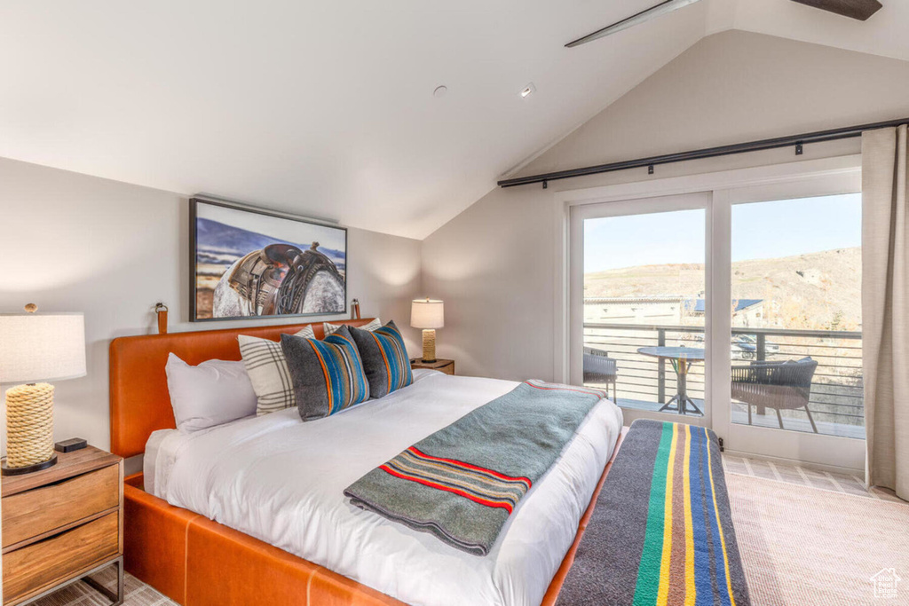 Bedroom featuring lofted ceiling and carpet