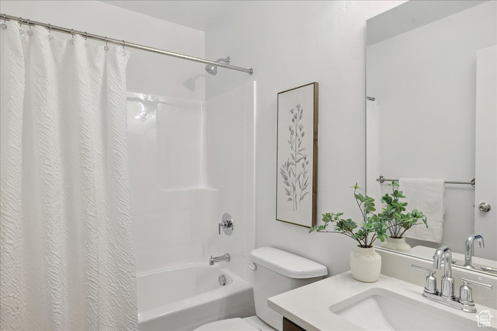 Full bath featuring vanity and shower / bath combination with curtain