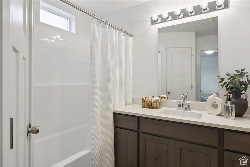 Bathroom featuring vanity and shower / tub combo