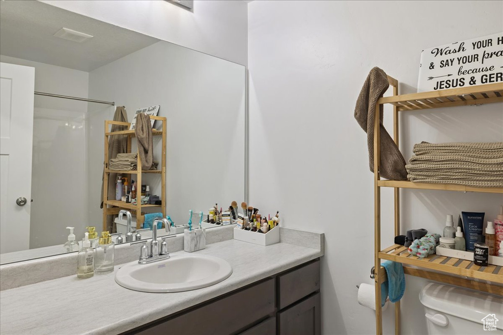 Bathroom with vanity and a shower