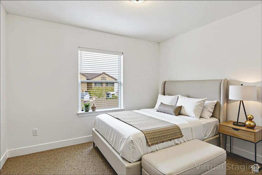 Bedroom featuring baseboards and carpet