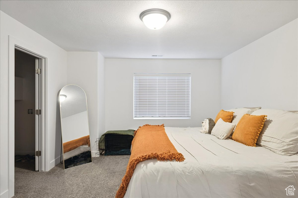 Carpeted bedroom with baseboards