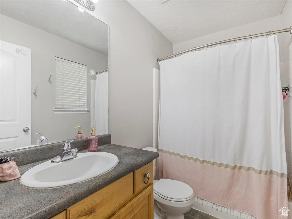 Bathroom with vanity and curtained shower