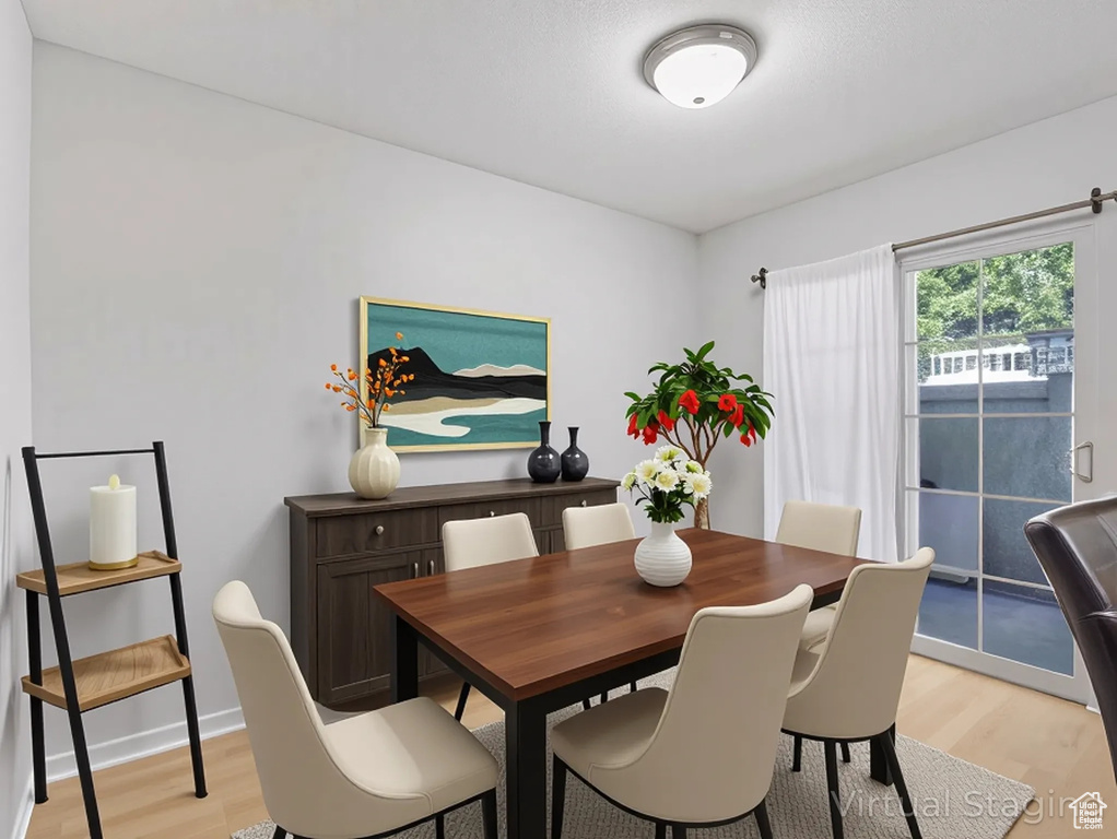 Dining area featuring light wood finished floors and baseboards