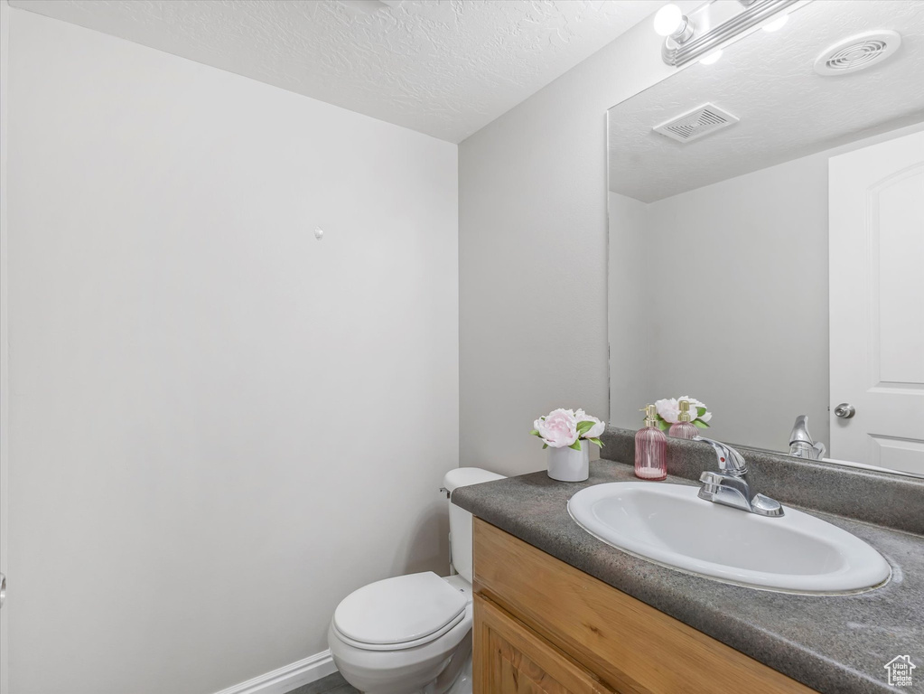 Bathroom with vanity and a textured ceiling