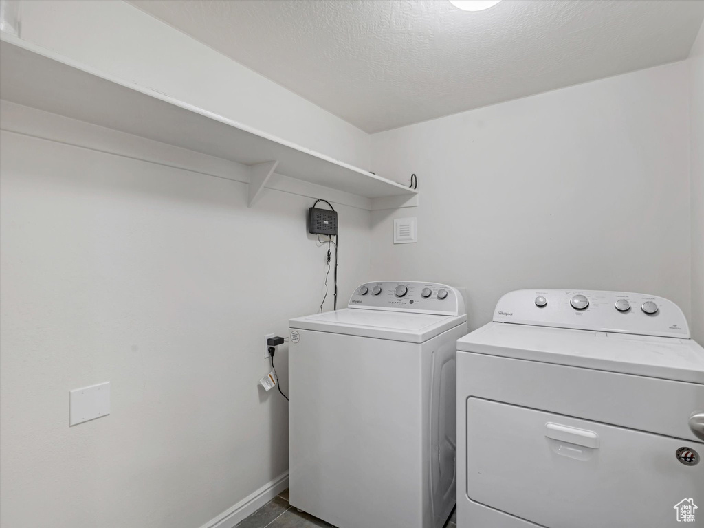 Laundry area with independent washer and dryer and baseboards