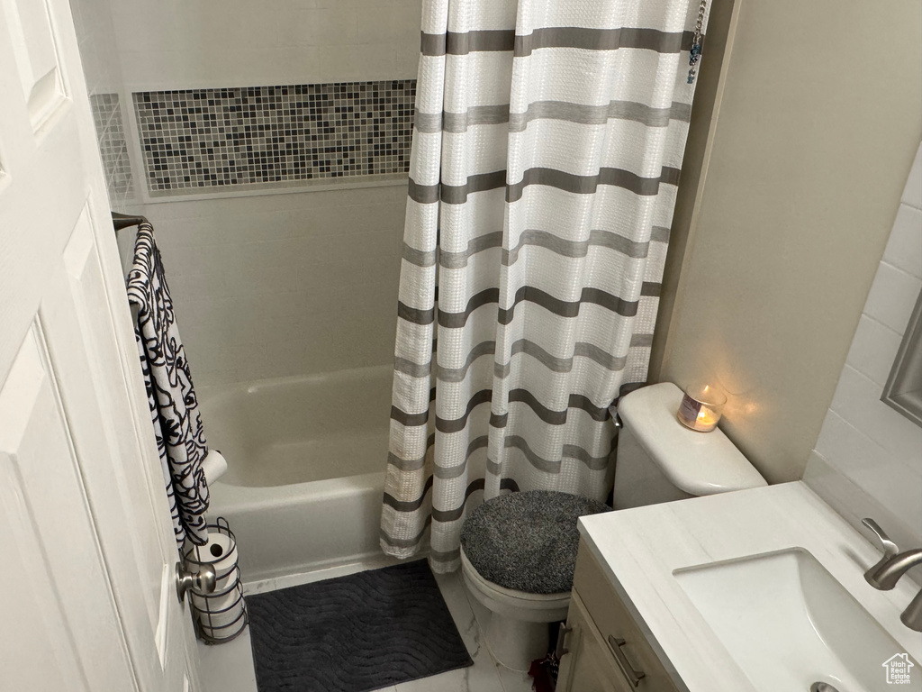 Full bathroom with shower / tub combo with curtain and vanity