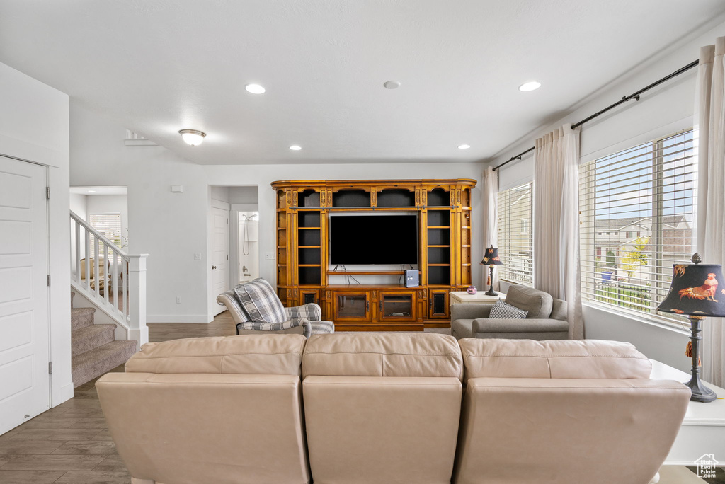 Living room featuring recessed lighting and stairway