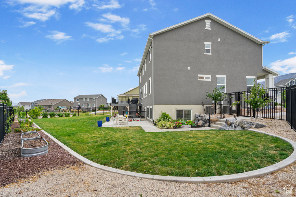 Rear view of property featuring a patio, a fenced backyard, stucco siding, and a residential view