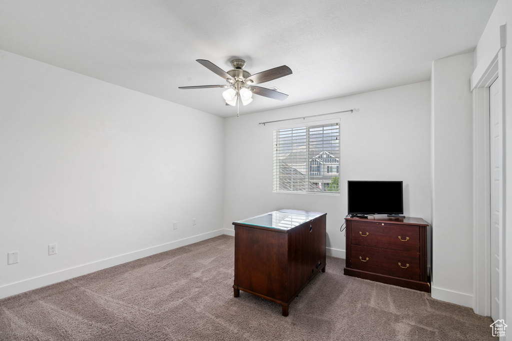 Unfurnished office featuring ceiling fan and carpet floors