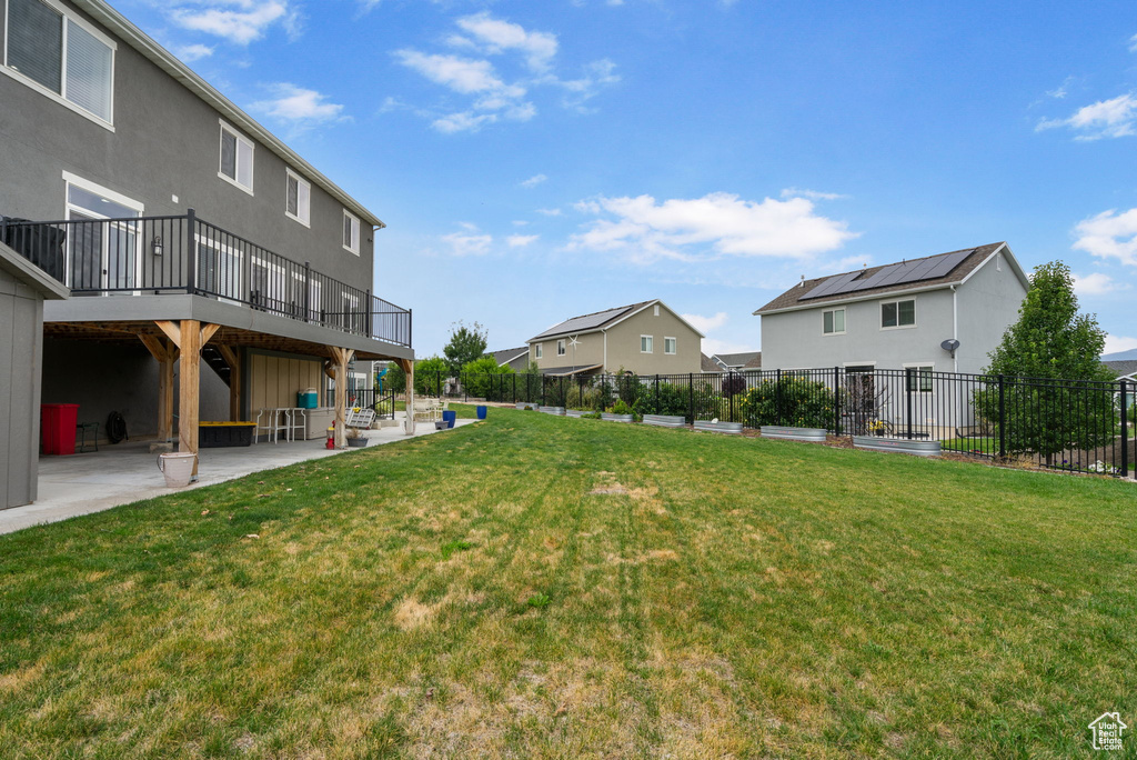 View of yard with a patio, a deck, and a residential view