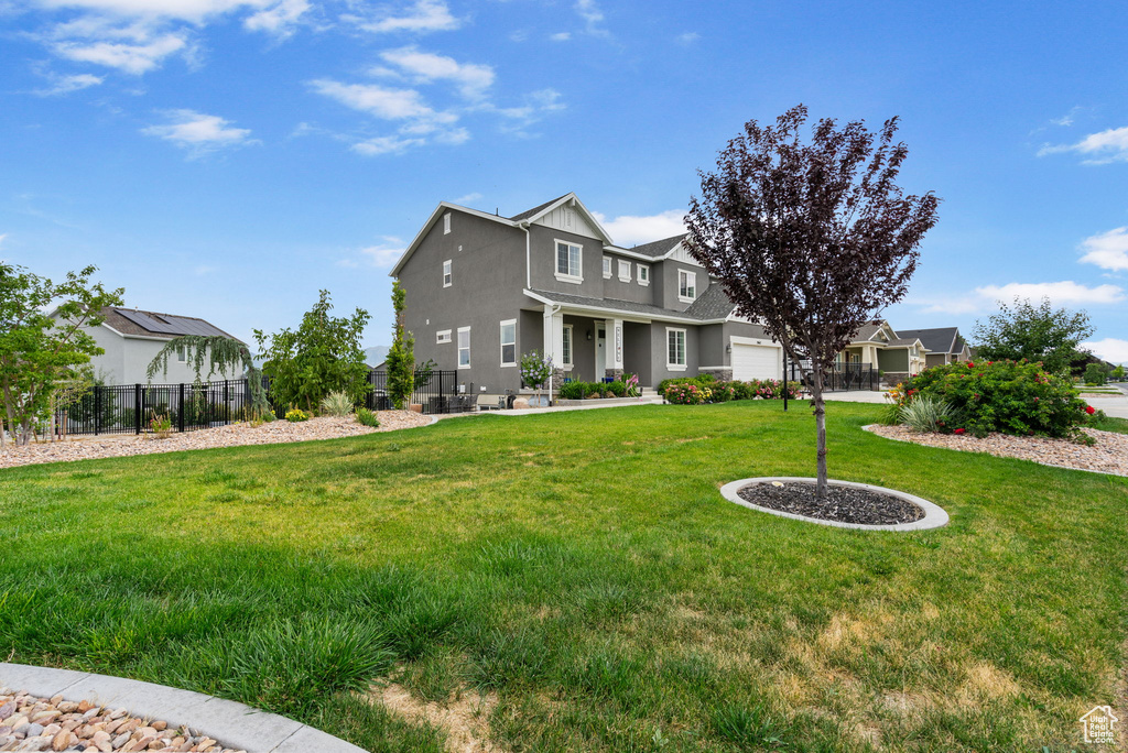 View of front of property featuring a garage and stucco siding