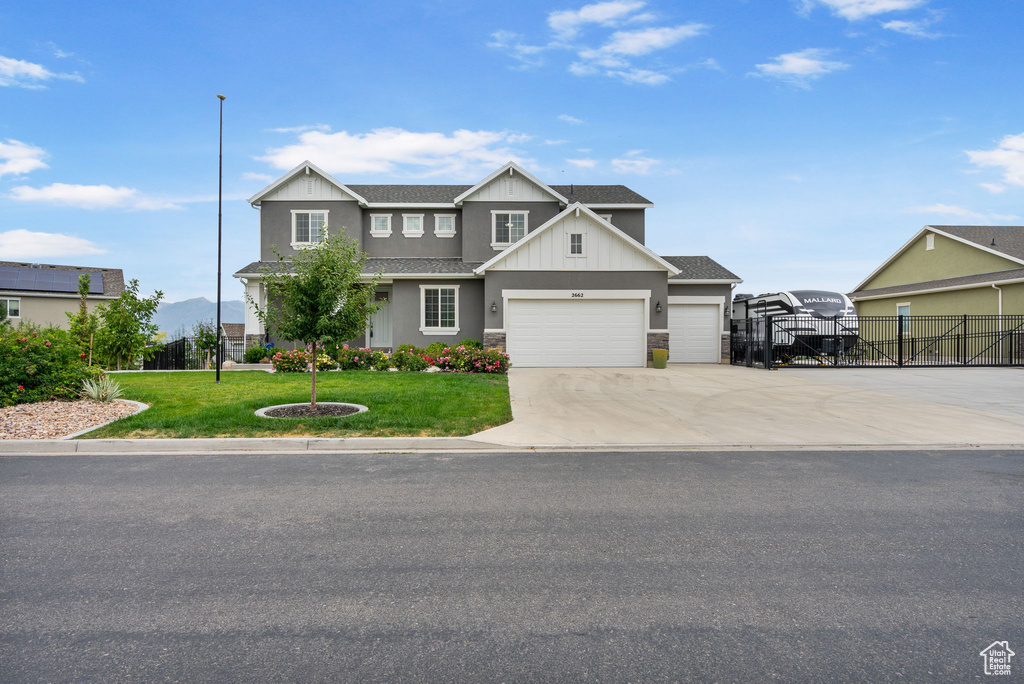 View of front of property featuring concrete driveway, a garage, roof with shingles, and board and batten siding