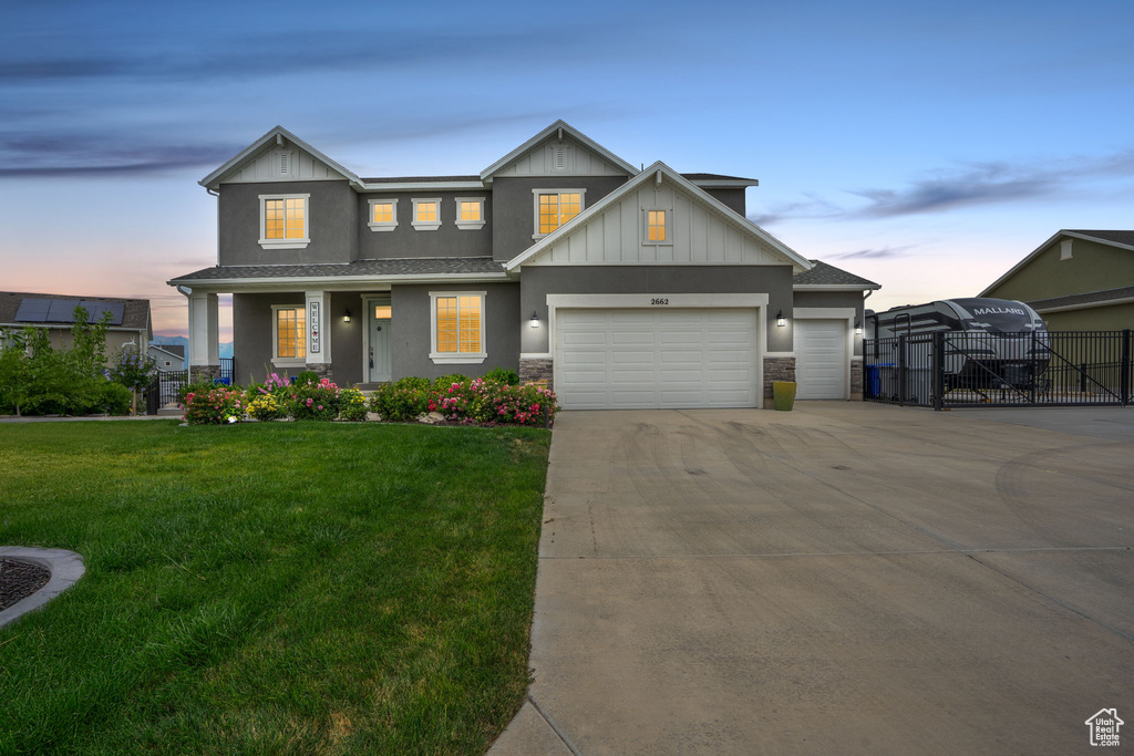 View of front of home featuring an attached garage, concrete driveway, a gate, a porch, and board and batten siding