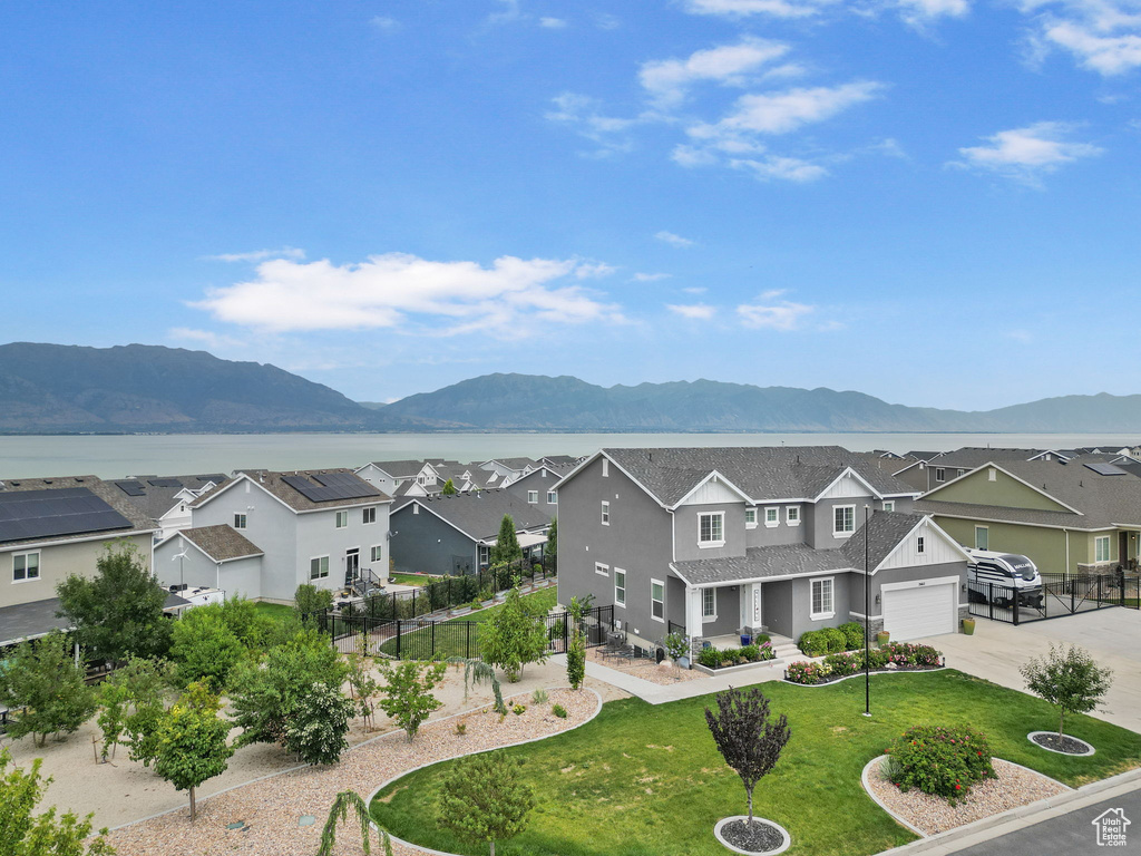 View of mountain backdrop featuring nearby suburban area and a nearby body of water