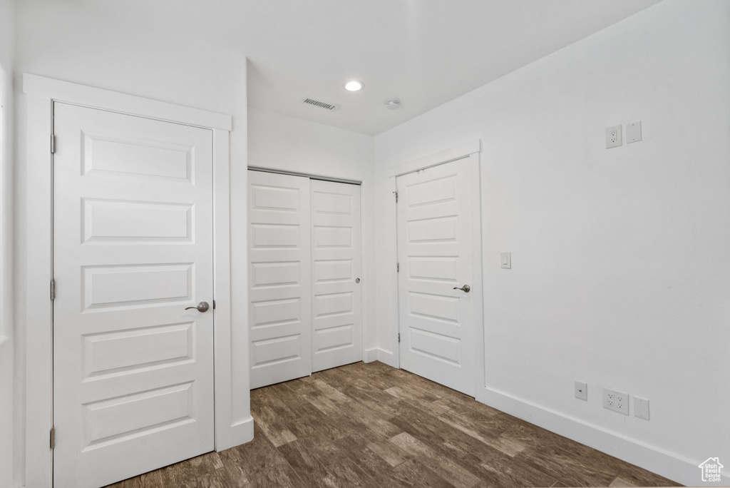 Unfurnished bedroom with dark wood finished floors, a closet, and recessed lighting