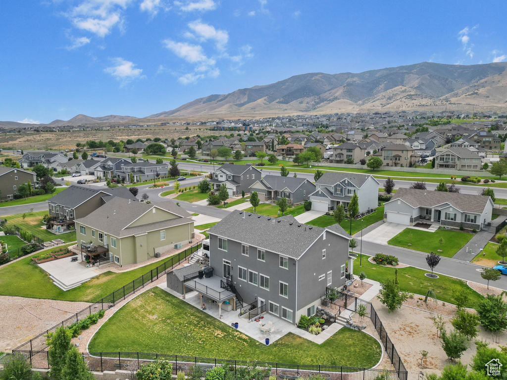 Aerial view of residential area featuring a mountainous background