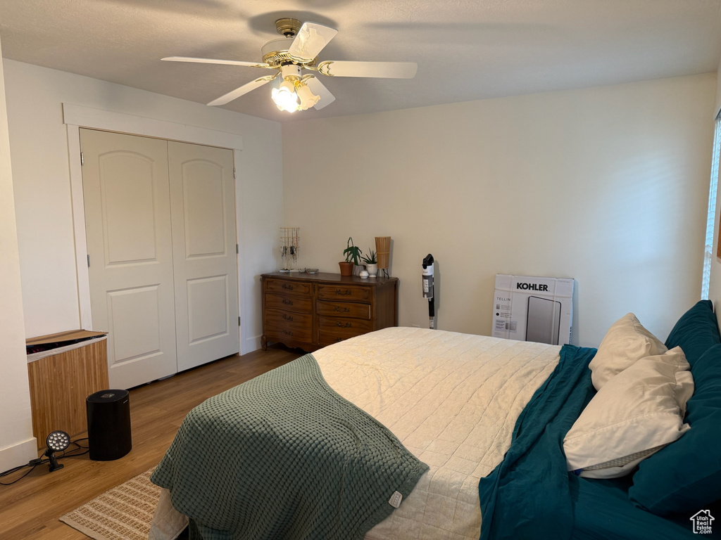 Bedroom featuring a closet, wood finished floors, and a ceiling fan