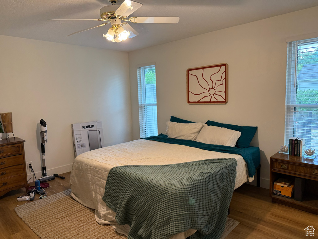 Bedroom with wood finished floors and ceiling fan
