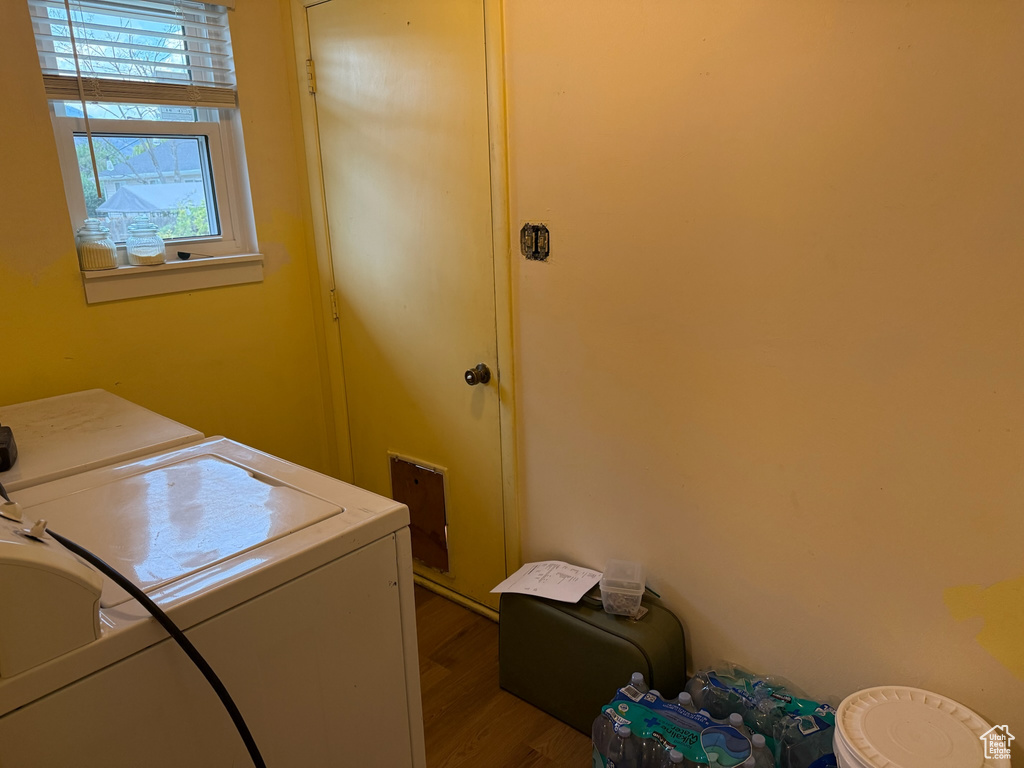 Laundry room featuring independent washer and dryer and wood finished floors