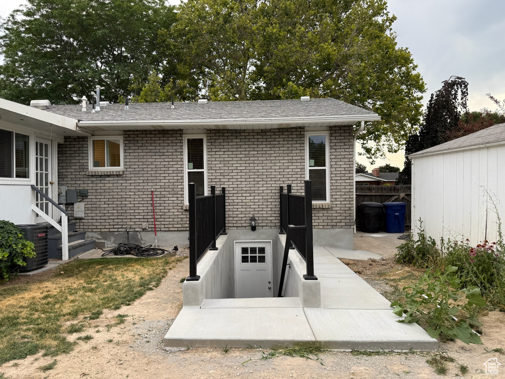 View of storm shelter featuring entry steps
