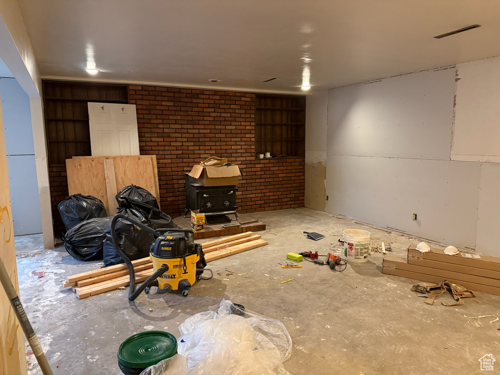 Unfurnished living room with brick wall