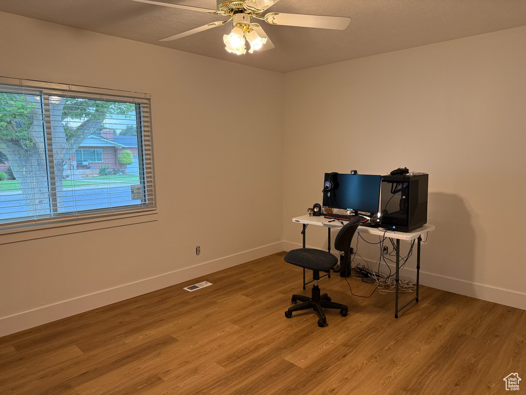 Office featuring light wood-type flooring and ceiling fan